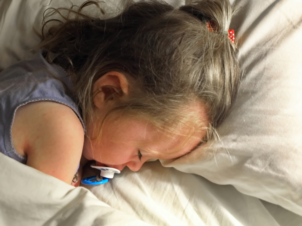 Exhausted preschooler resting after a long day