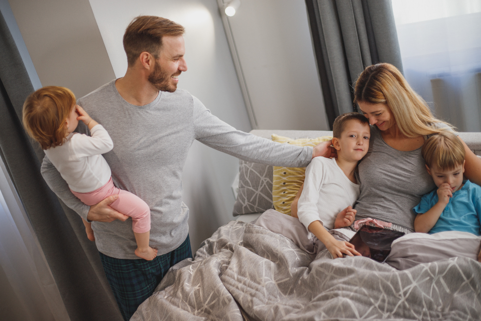 Pin graphic: parents and kids together during a busy family morning