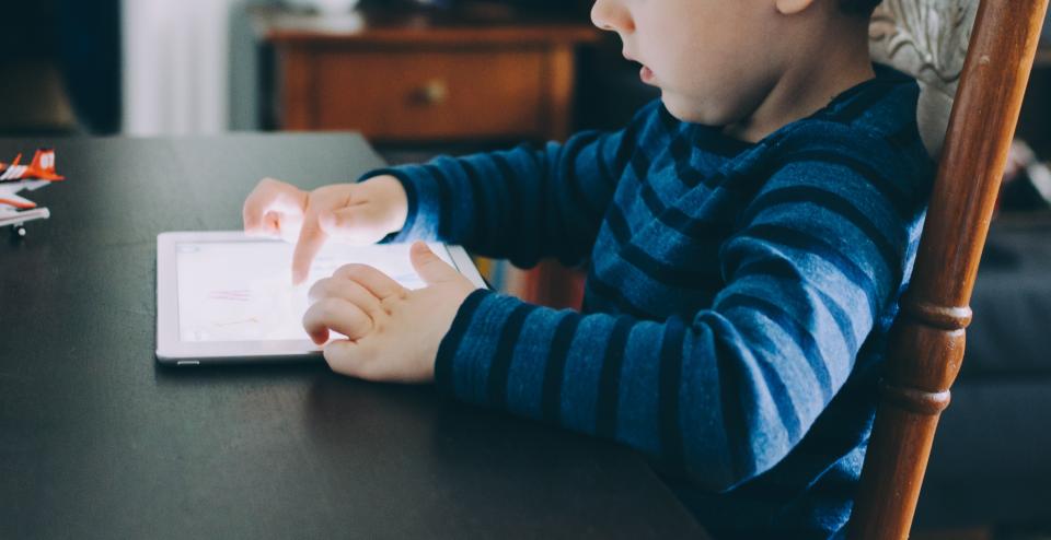 Toddler boy playing quietly, still building early language skills